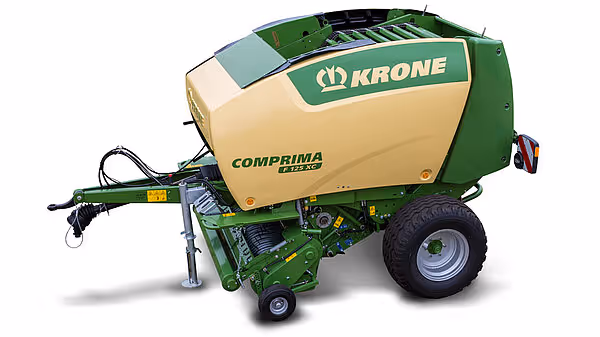 KRONE Comprima rundballpresse vist fra siden på hvit bakgrunn.