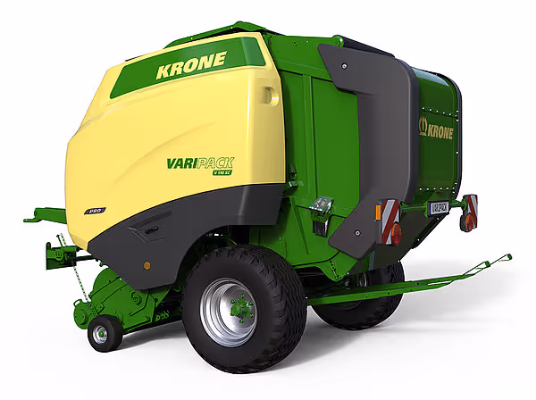 KRONE Varipack rundballpresse i grønn og gul farge sett fra høyre bakside. Maskinen har store hjul og er designet for å lage rundballer av høy eller halm.